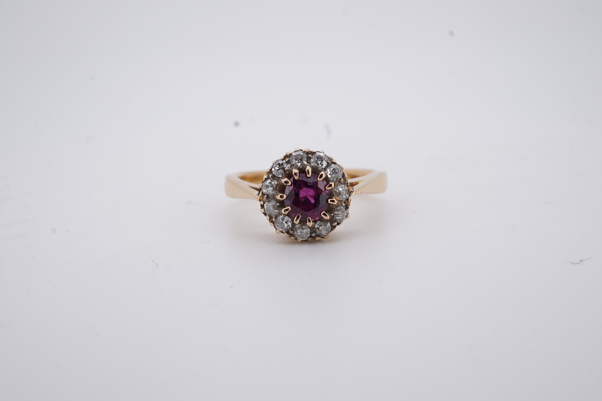 A George V 18ct gold, ruby and diamond set circular cluster ring, size M, gross weight 5 grams.
